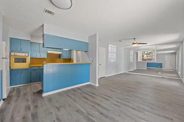 a view of a kitchen with a sink and cabinets