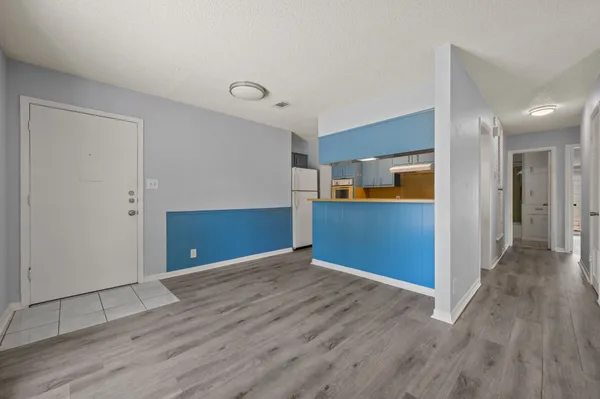 a view of a kitchen with wooden floor
