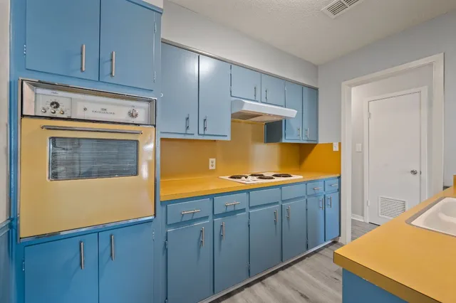 a kitchen with stainless steel appliances granite countertop wooden cabinets a sink and dishwasher