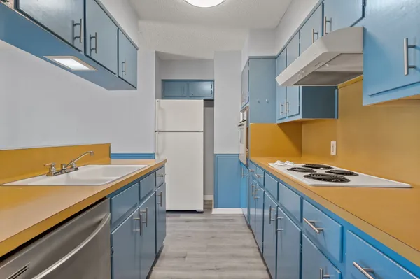 a kitchen with a sink and a refrigerator