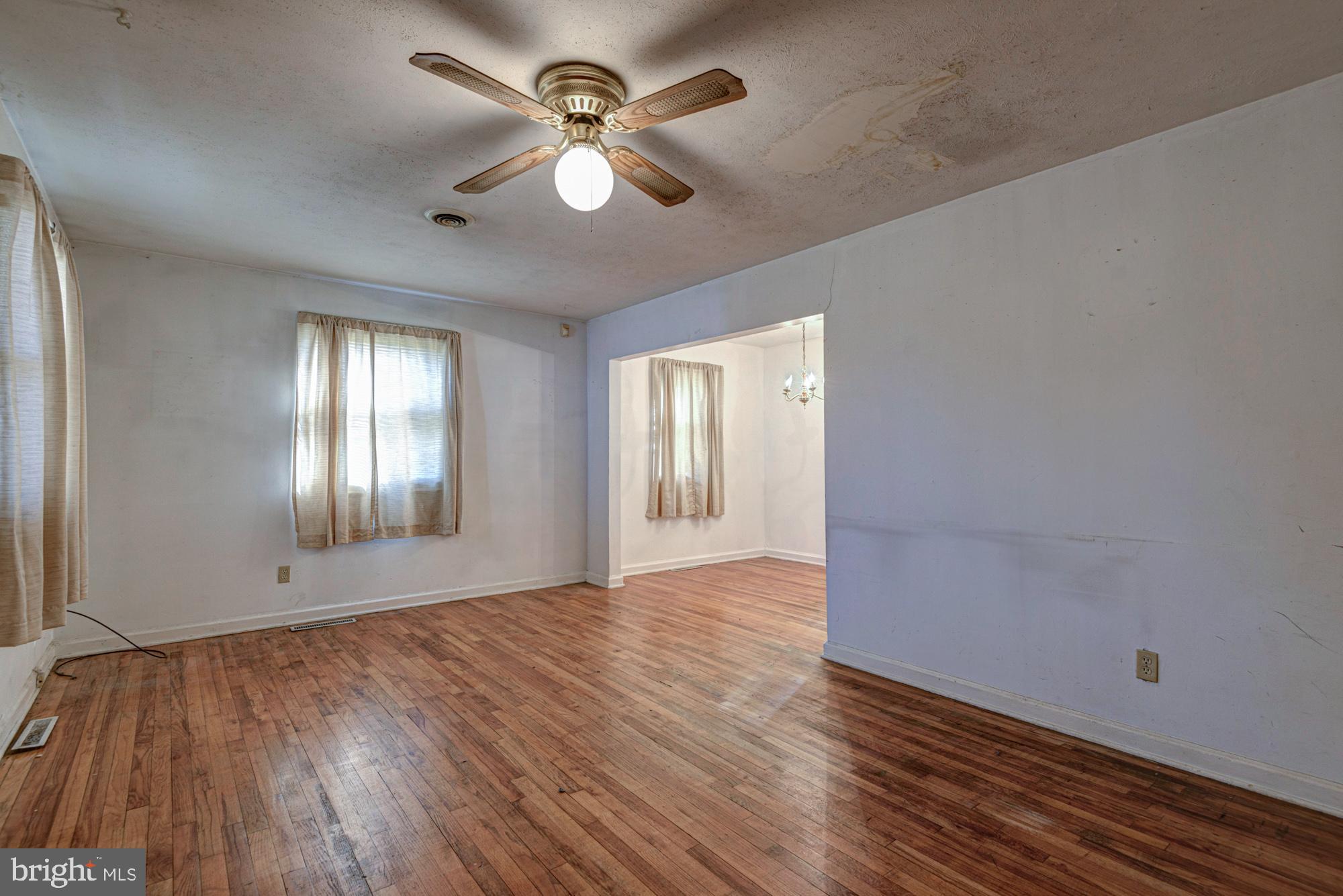 321 Bassett Avenue New Castle, DE 19720 - Photo 11 of 29 a view of an empty room with window and wooden floor
