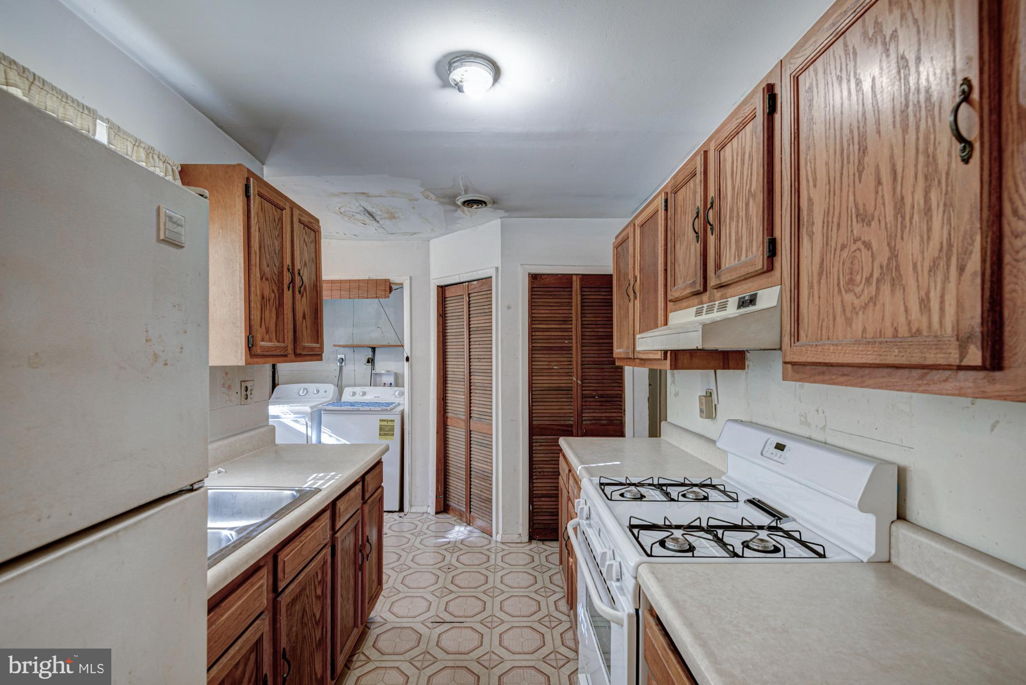 321 Bassett Avenue New Castle, DE 19720 - Photo 18 of 29 a kitchen with stainless steel appliances granite countertop a stove refrigerator sink and cabinets