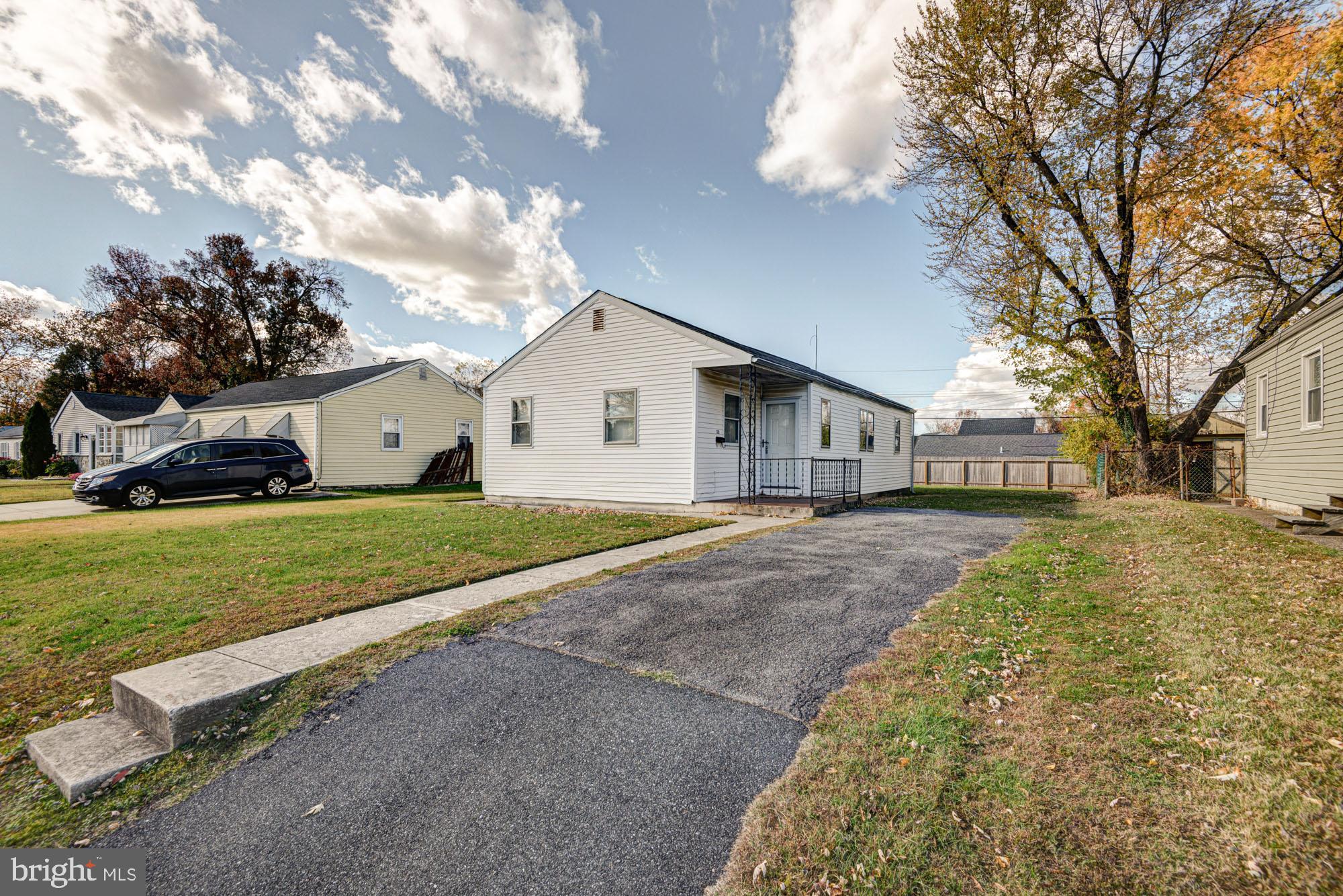 321 Bassett Avenue New Castle, DE 19720 - Photo 2 of 29 a view of a house with a yard and garage