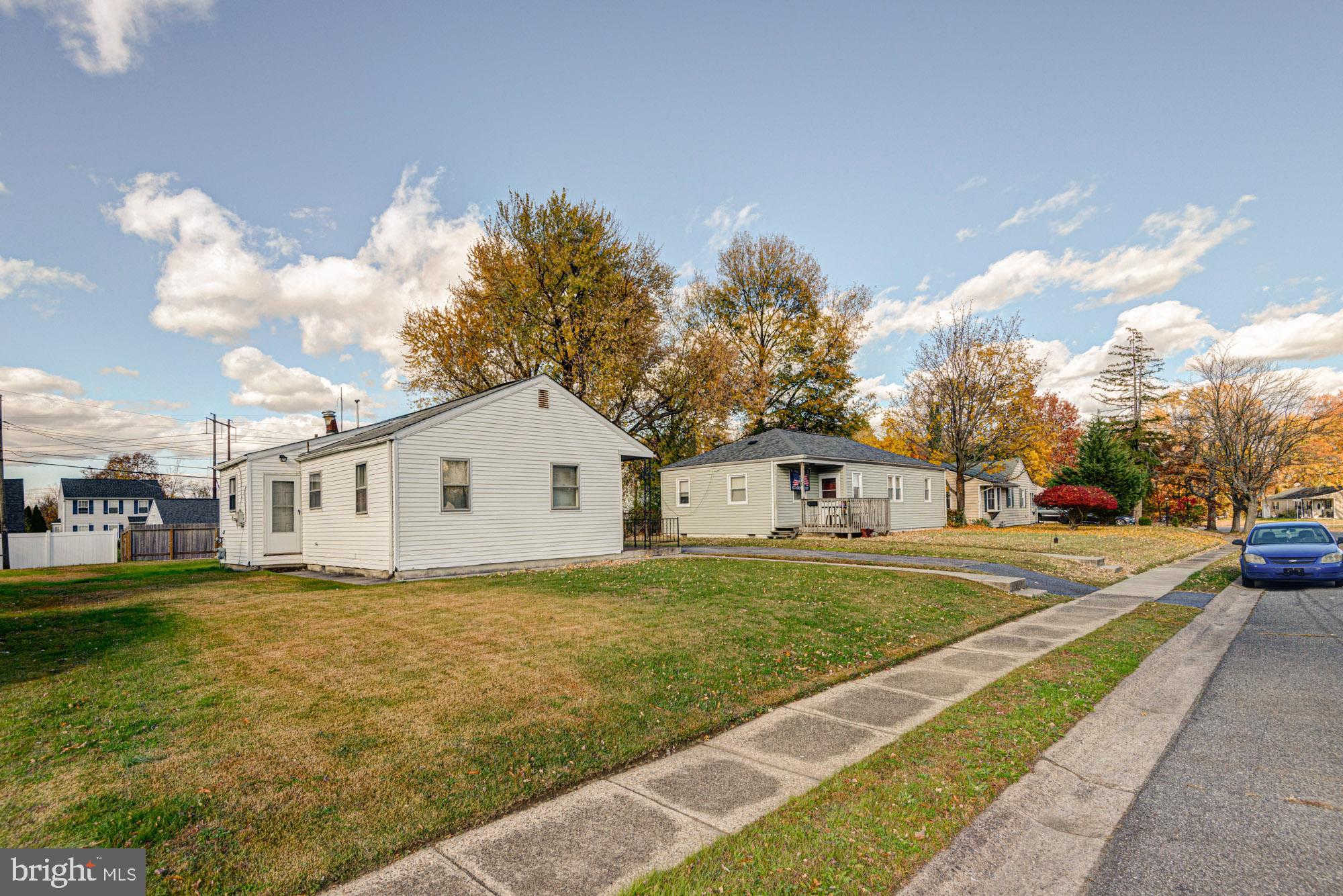 321 Bassett Avenue New Castle, DE 19720 - Photo 5 of 29 a view of a house with a big yard and large trees