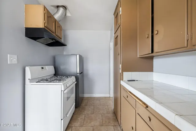 a kitchen with a sink a stove and a microwave oven