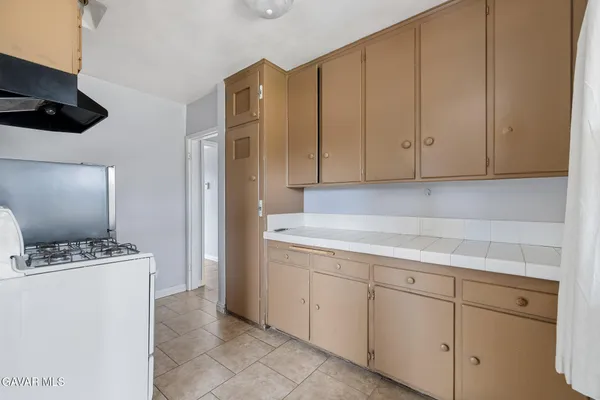 a kitchen with cabinets and appliances