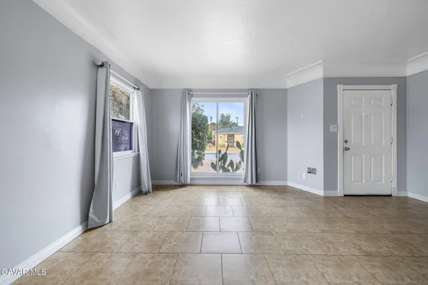 an empty room with windows and closet