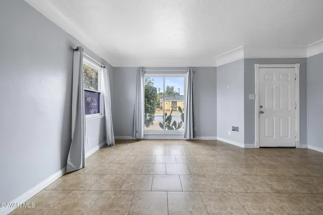 an empty room with windows and closet