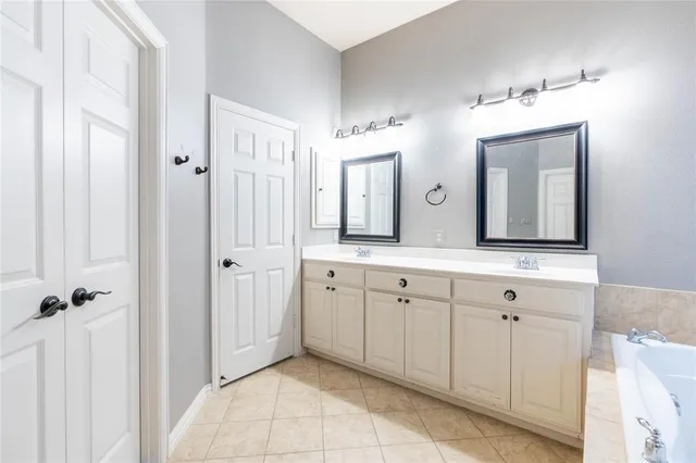 a spacious bathroom with a double vanity sink mirror and
