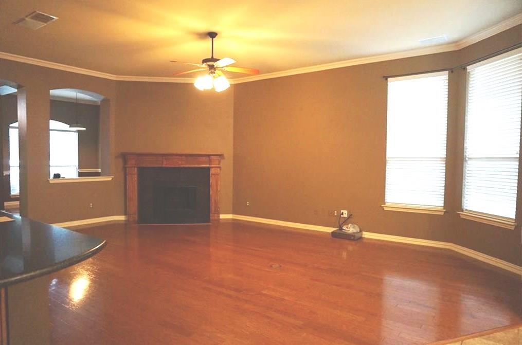 935 Panther Lane Allen, TX 75013 - Photo 6 of 20 an empty room with windows and fireplace