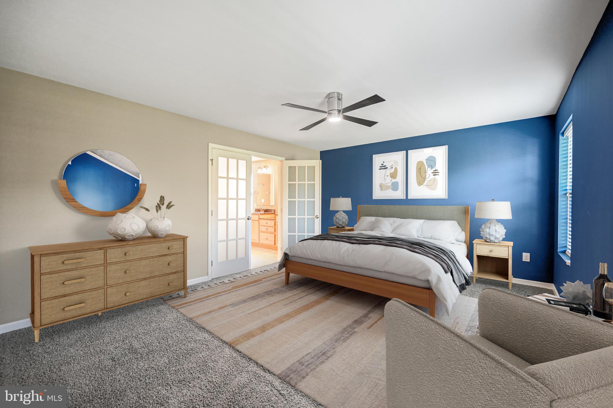 3265 Lewisberry Road York, PA 17404 - Photo 5 of 34 a spacious bedroom with a large bed and a chandelier