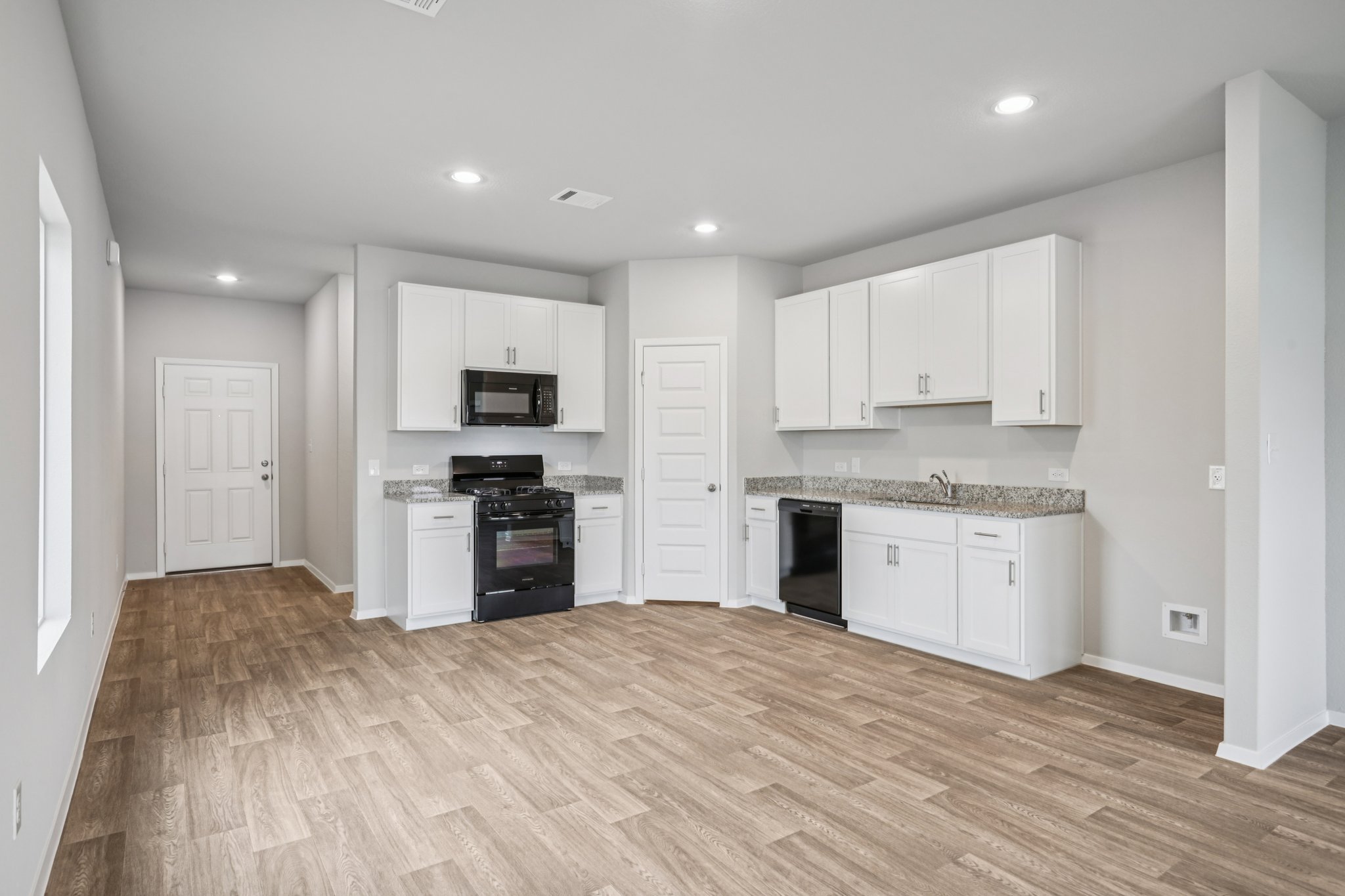 104 Summer Drive Elgin, TX 78621 - Photo 10 of 40 a kitchen with granite countertop white cabinets and stainless steel appliances