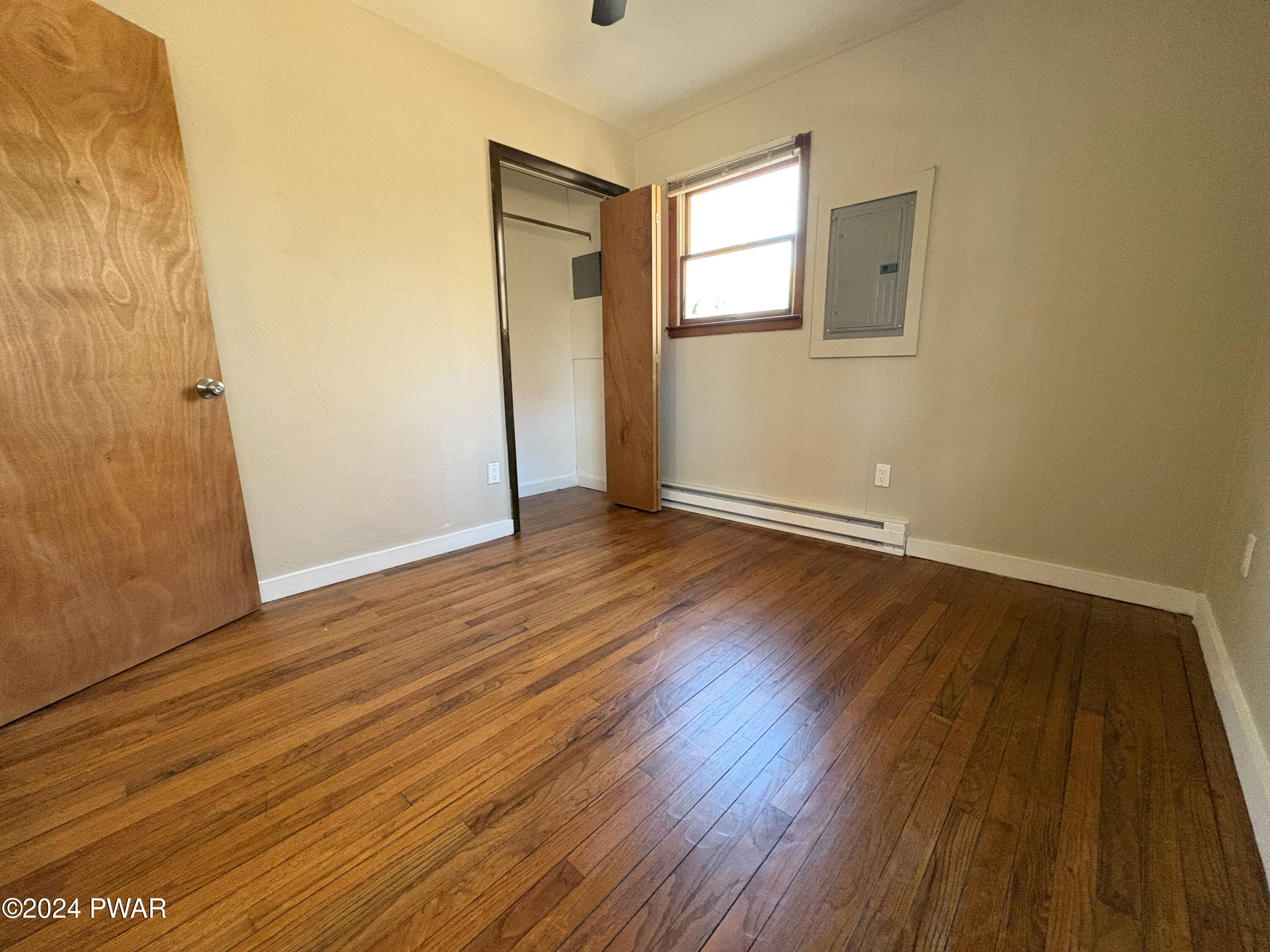 120 Slaymaker Road Milford, PA 18337 - Photo 16 of 28 an empty room with wooden floor and windows