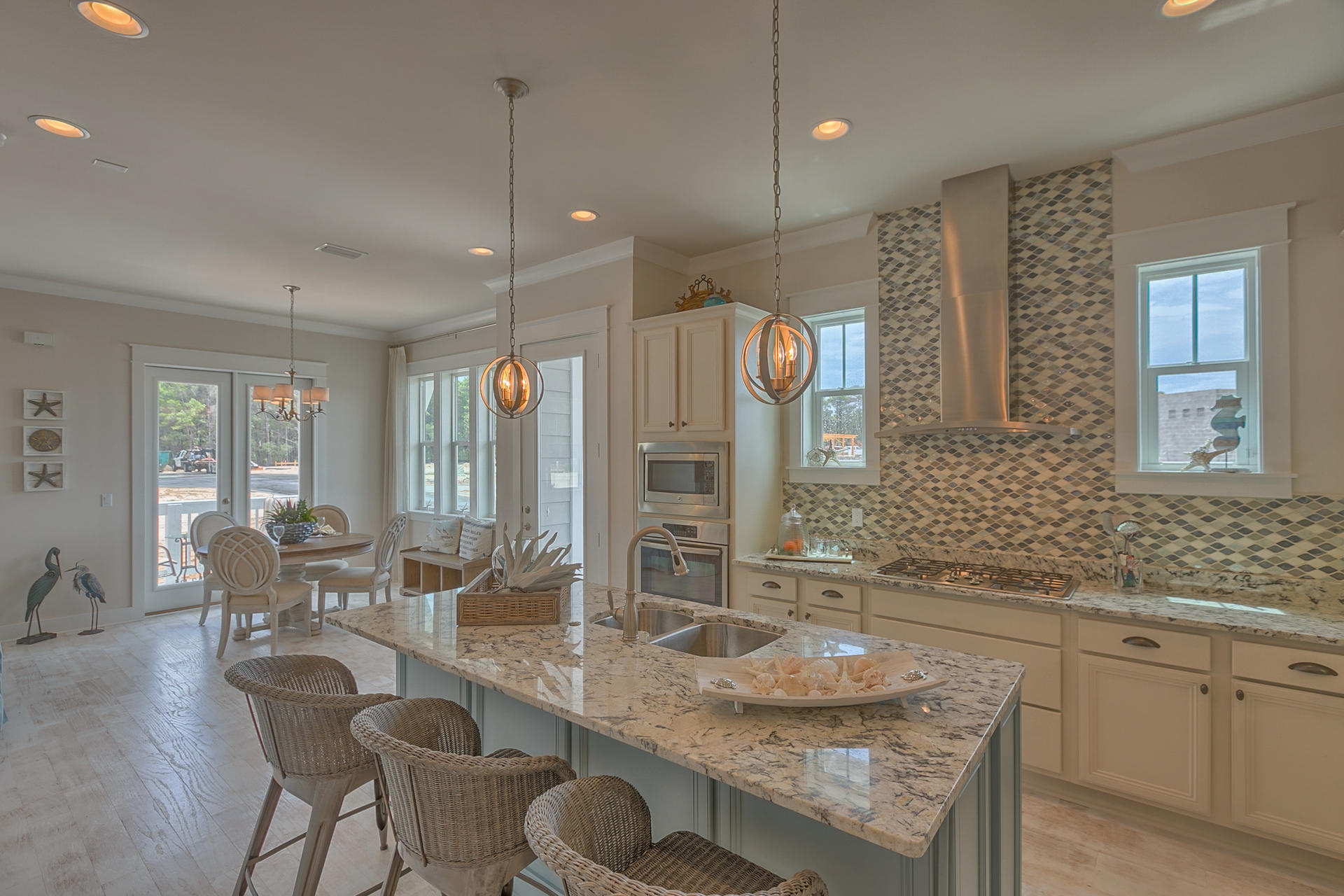 336 Milestone Dr Inlet Beach, Unit 534B Inlet Beach, FL 32461 - Photo 14 of 50 a kitchen with granite countertop a stove a sink a dining table and chairs