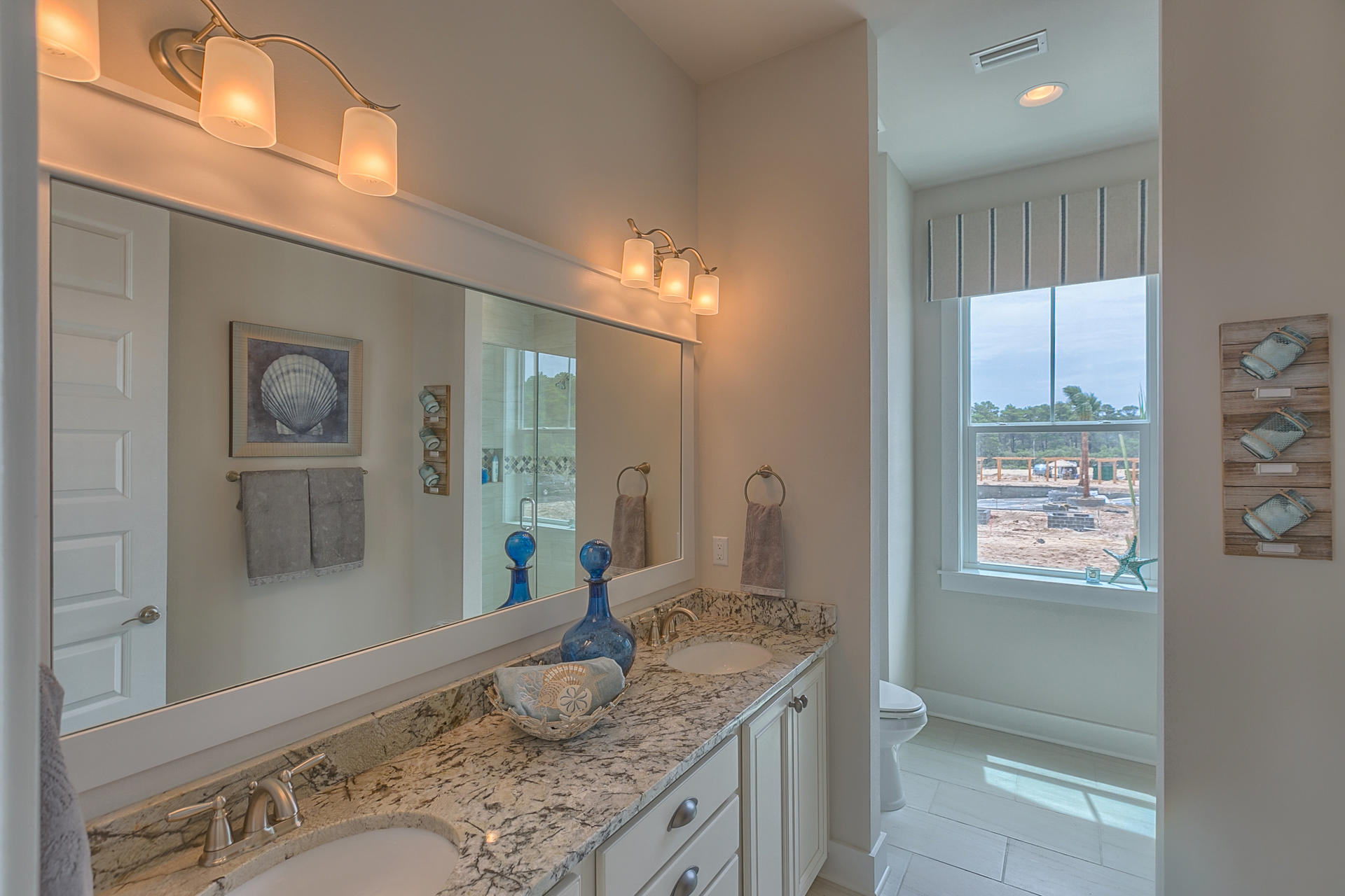 336 Milestone Dr Inlet Beach, Unit 534B Inlet Beach, FL 32461 - Photo 22 of 50 a bathroom with a granite countertop sink a mirror and a shower