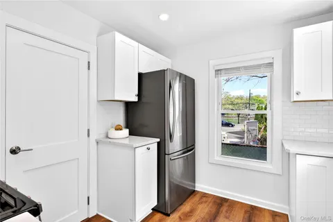 a kitchen with a refrigerator and a stove top oven