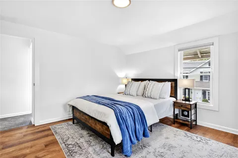 a bed room with a bed and a chair