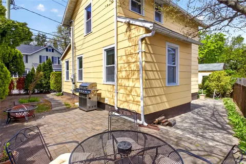 a view of a patio with table and chairs potted plants