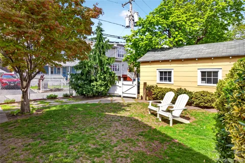 a white bench sitting in front of a house
