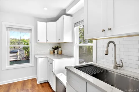 a kitchen with a sink cabinets and window