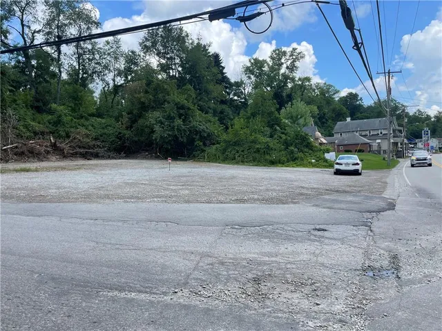 a view of a road with a bench in front of it