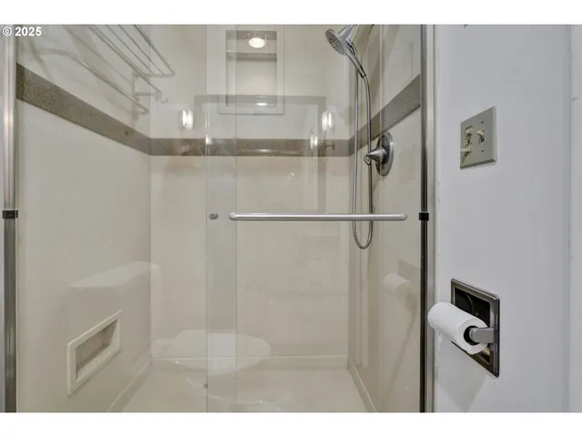 a bathroom with a sink shower and a mirror