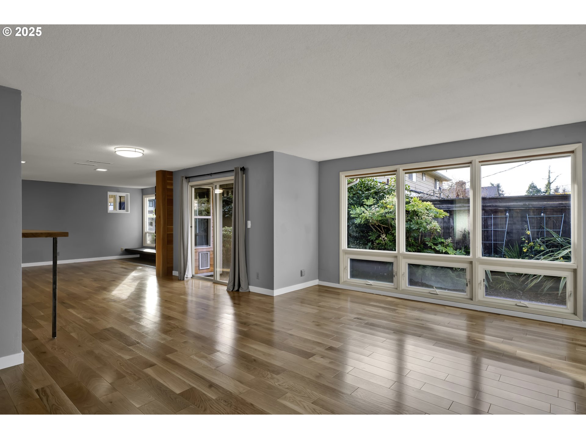 2140 Tabor Street Eugene, OR 97401 - Photo 4 of 26 a view of an empty room with wooden floor and a window