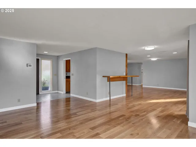 a view of an empty room with a fireplace and a window