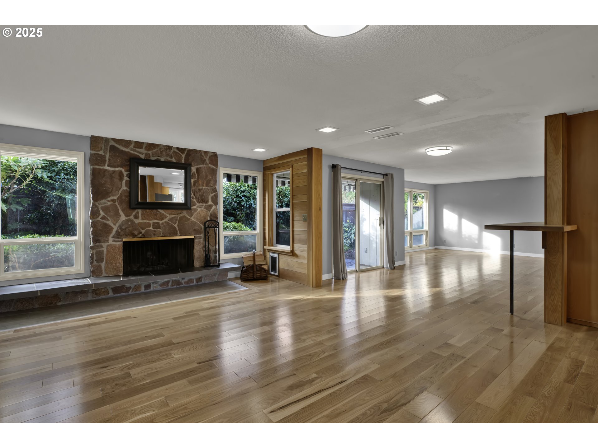 2140 Tabor Street Eugene, OR 97401 - Photo 7 of 26 a view of empty room with wooden floor and fireplace
