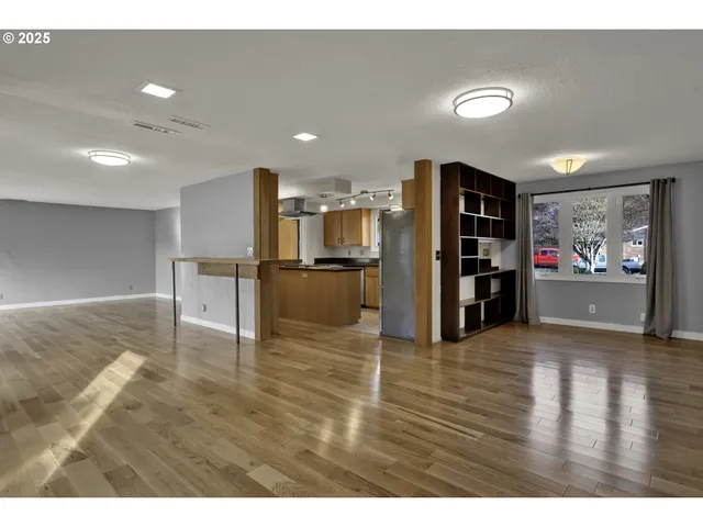 a kitchen that has a sink a stove cabinets counter space and a window