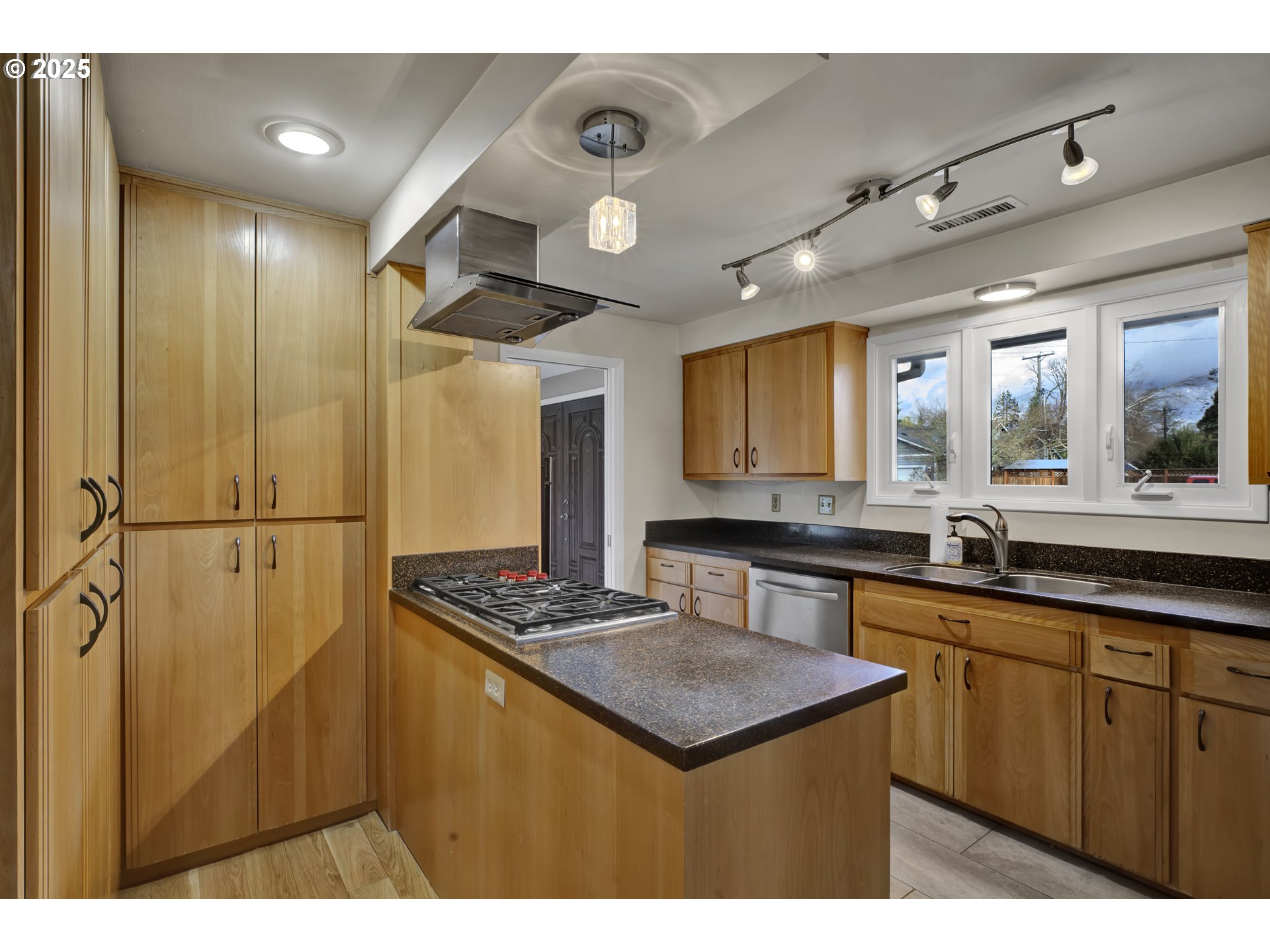 2140 Tabor Street Eugene, OR 97401 - Photo 9 of 26 a kitchen that has a sink a stove cabinets counter space and a window