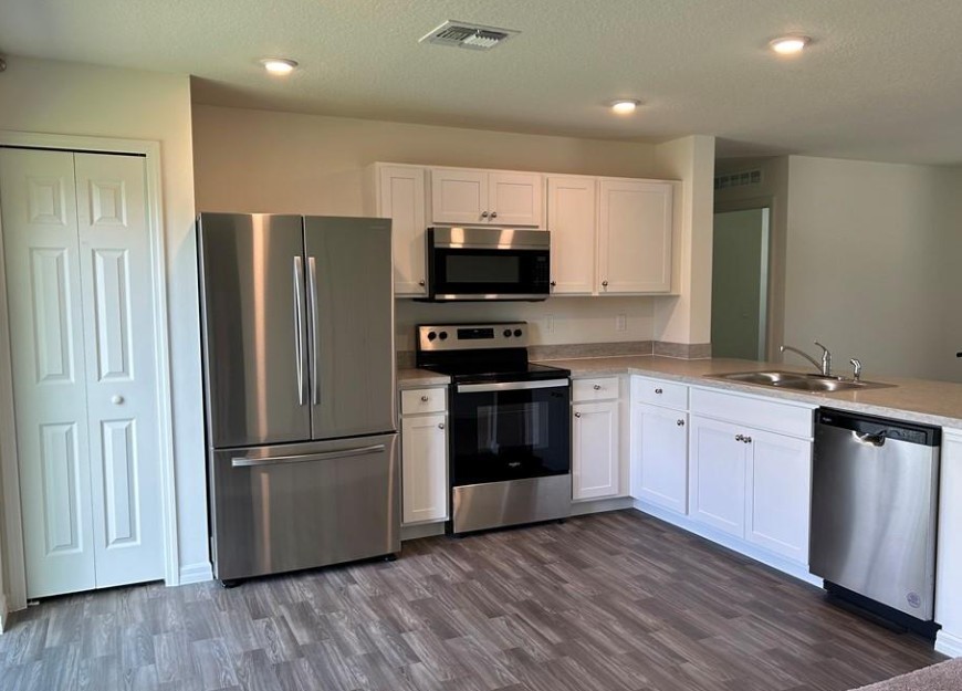 1352 Clearmont Street Sebastian, FL 32958 - Photo 2 of 9 a kitchen with a refrigerator and a stove top oven