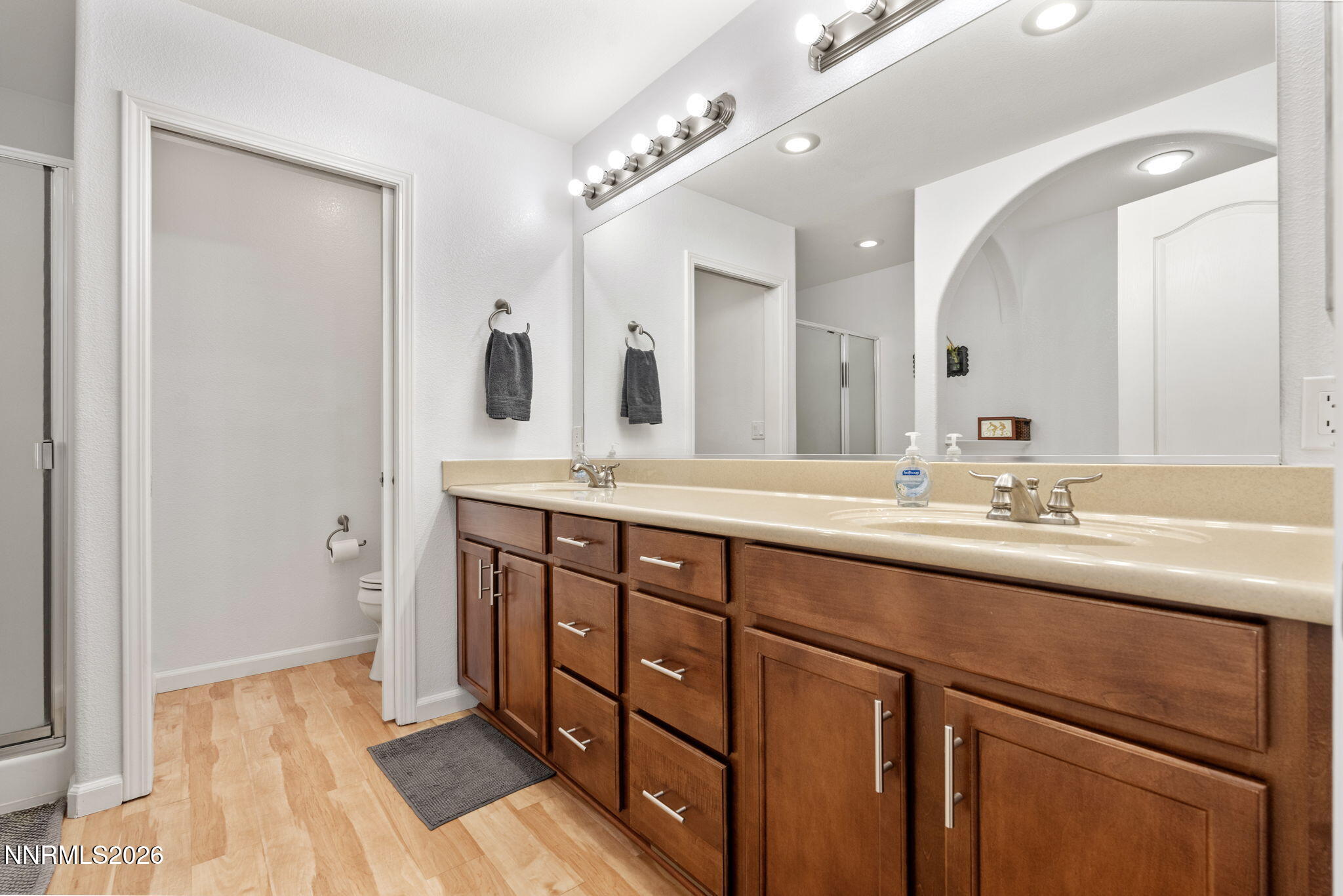 18324 Panda Bear Court Reno, NV 89508 - Photo 15 of 44 a bathroom with a double vanity sink a and mirror