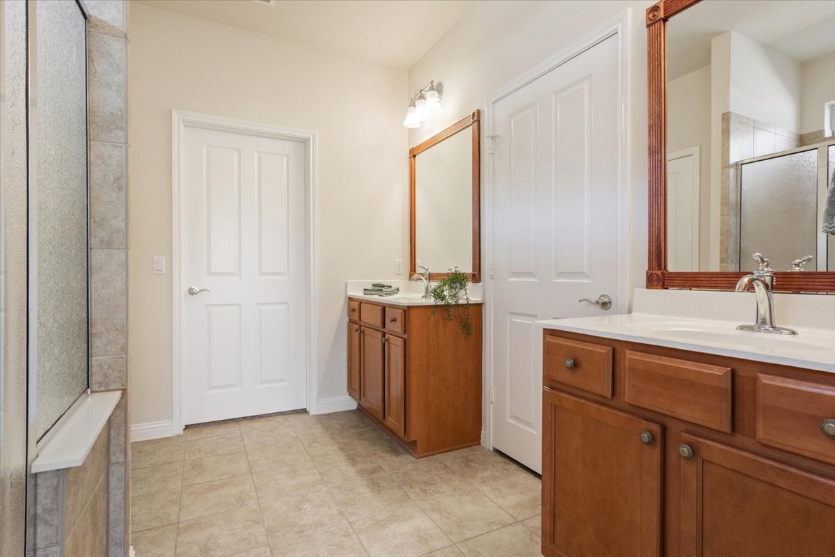 108 Cathedral Mountain Pass Georgetown, TX 78633 - Photo 21 of 36 a bathroom with a double vanity sink a mirror and a