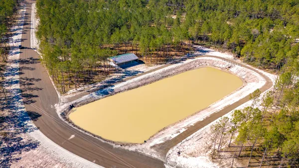 a view of a swimming pool with a outdoor seating and plants