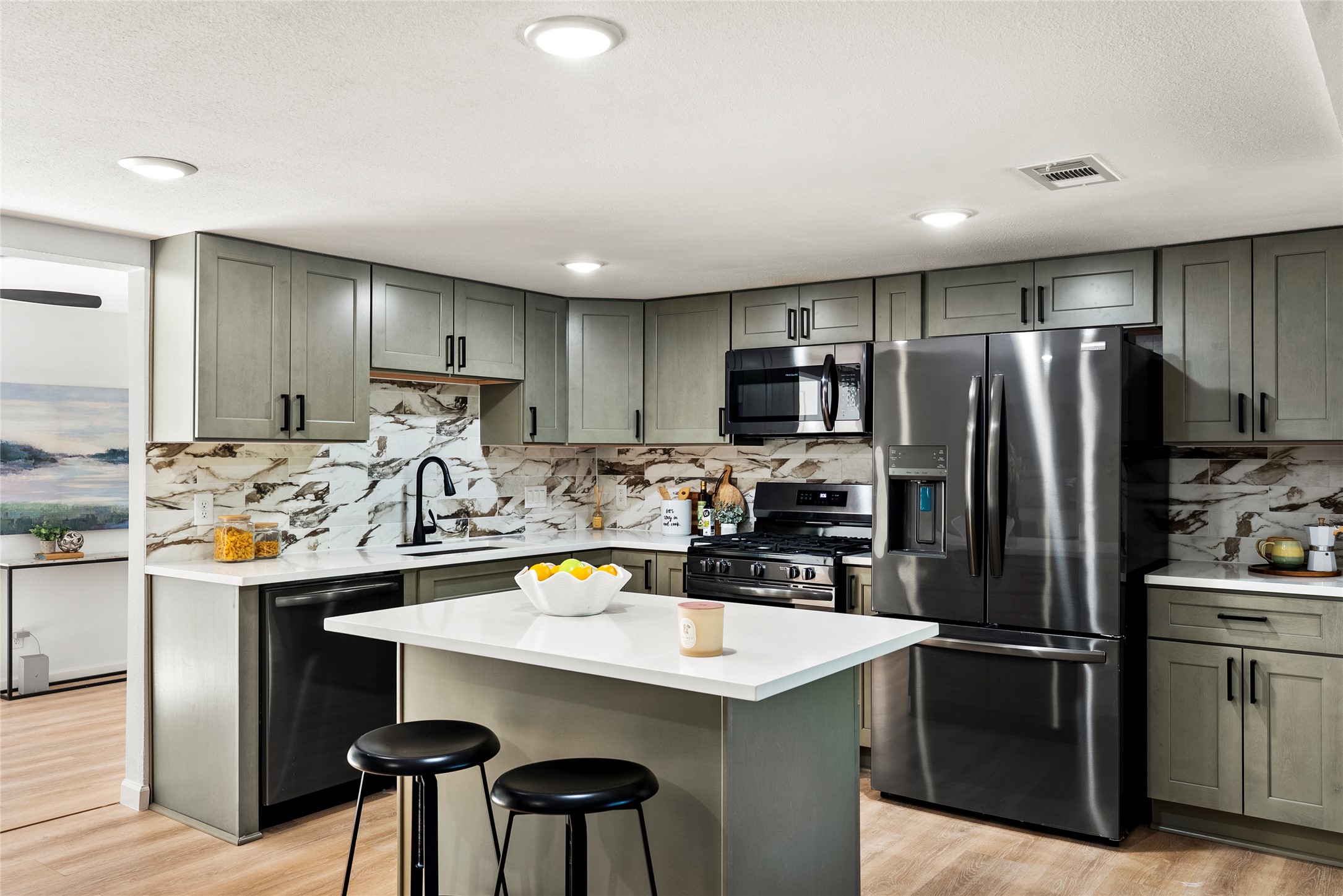 507 West Dittmar Road Austin, TX 78745 - Photo 13 of 40 a kitchen with kitchen island a refrigerator stove microwave and cabinets