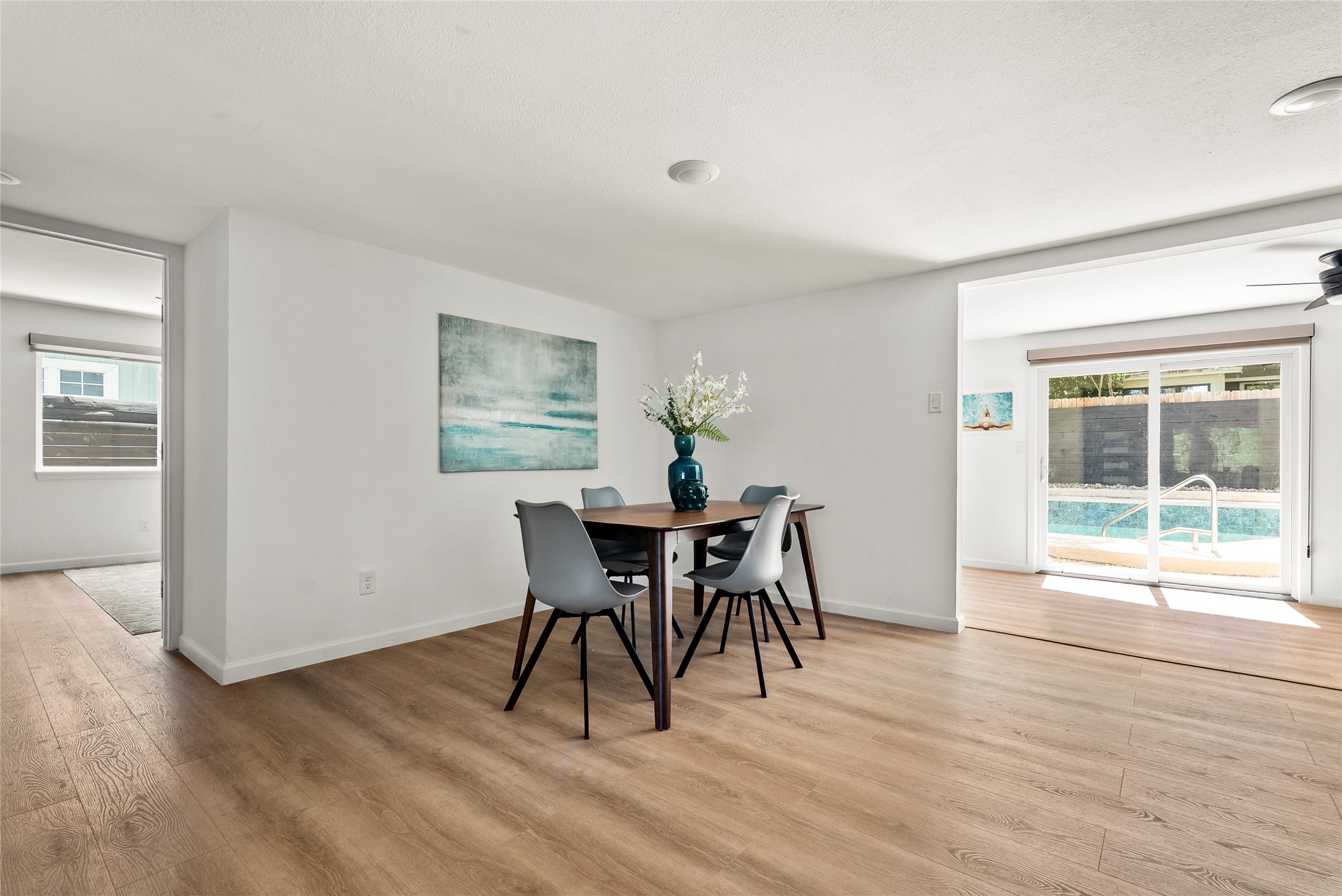 507 West Dittmar Road Austin, TX 78745 - Photo 16 of 40 a dining room with wooden floor a chandelier a glass table and chairs