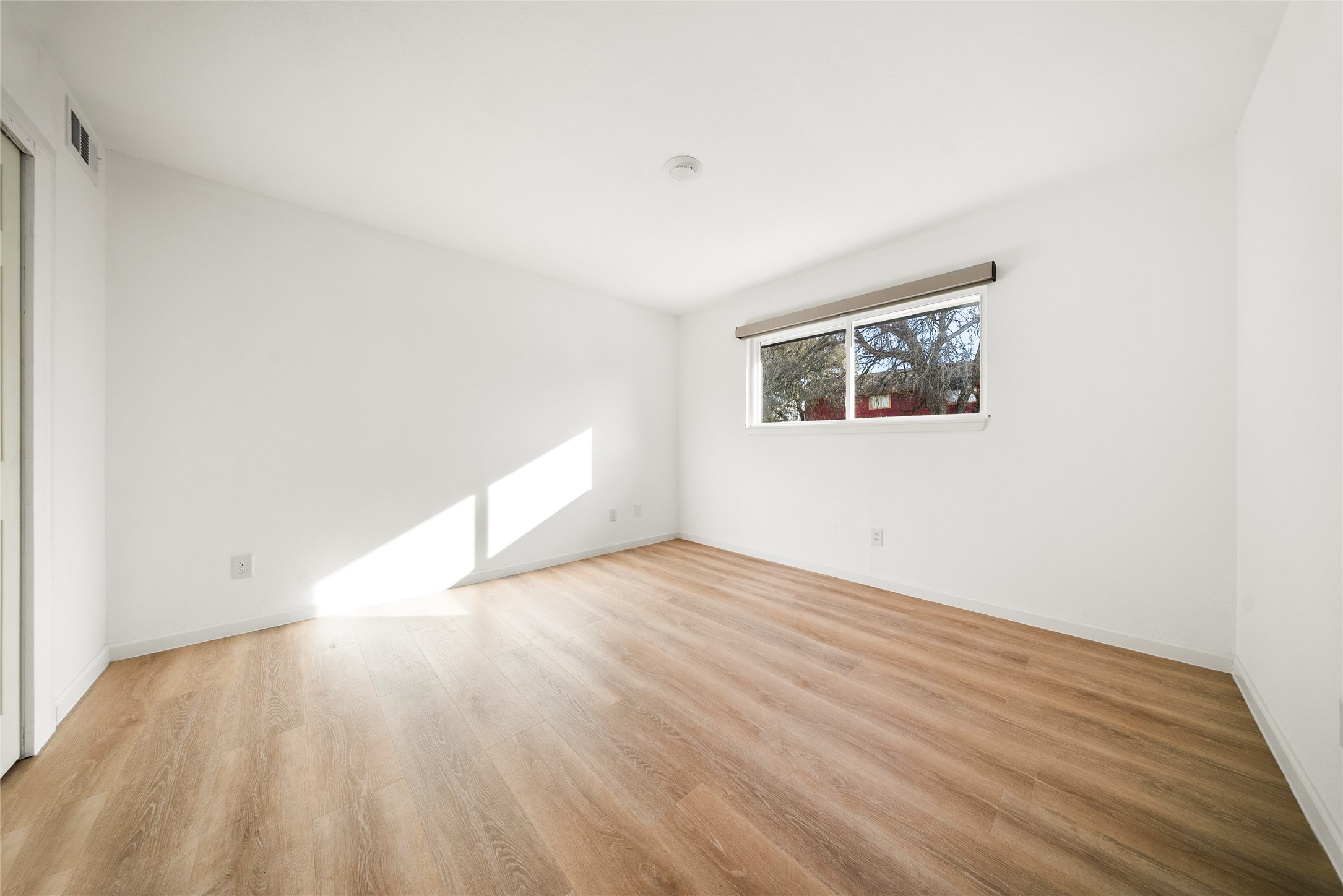 507 West Dittmar Road Austin, TX 78745 - Photo 25 of 40 a view of an empty room with wooden floor and a window
