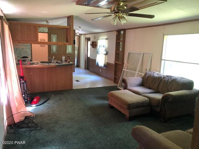 213 Slish Road Honesdale, PA 18431 - Photo 13 of 13 a living room with furniture and a chandelier