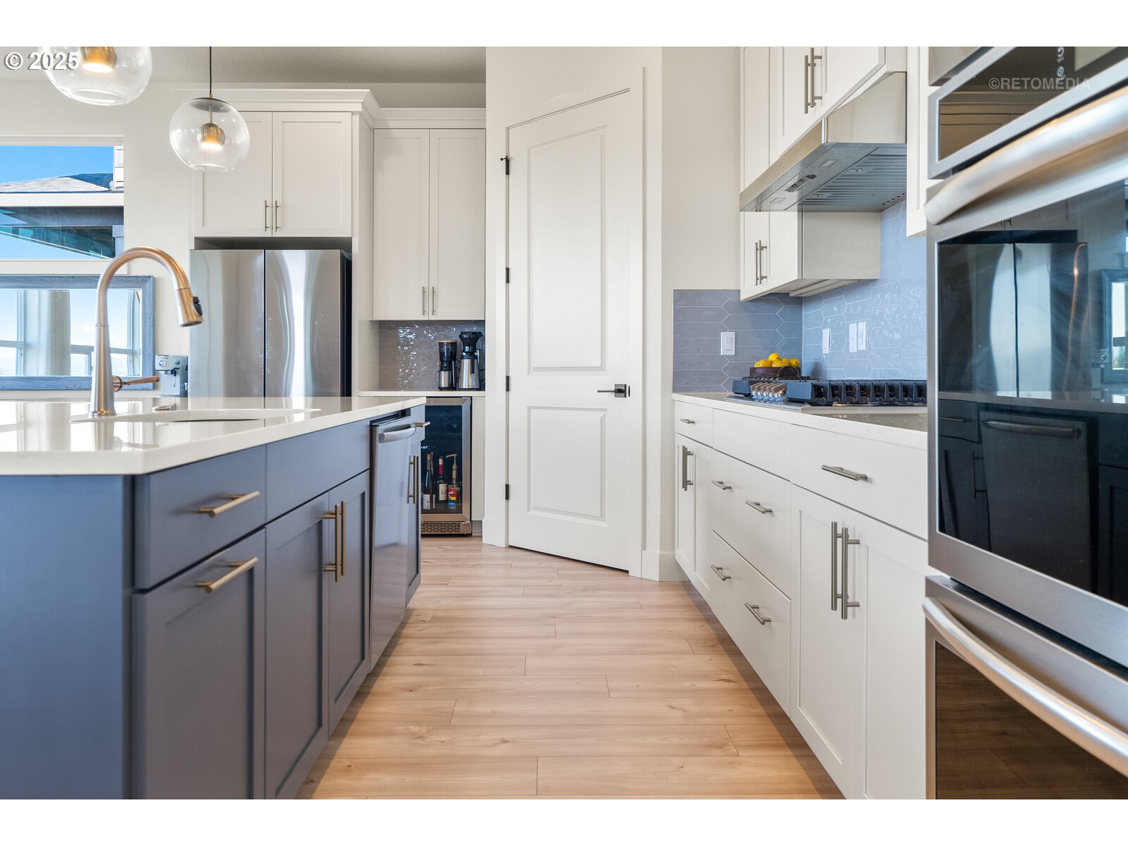 12305 Southwest Silvertip Street Beaverton, OR 97007 - Photo 13 of 43 a kitchen with stainless steel appliances granite countertop a refrigerator a sink dishwasher and white cabinets with wooden floor