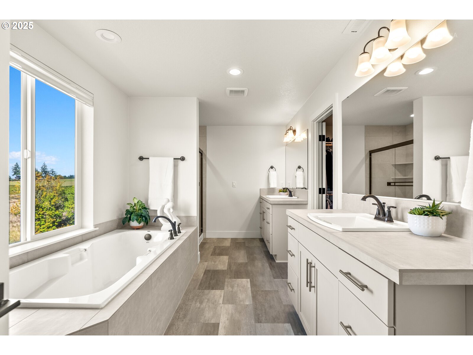 12305 Southwest Silvertip Street Beaverton, OR 97007 - Photo 28 of 43 a spacious bathroom with a tub sink and mirror