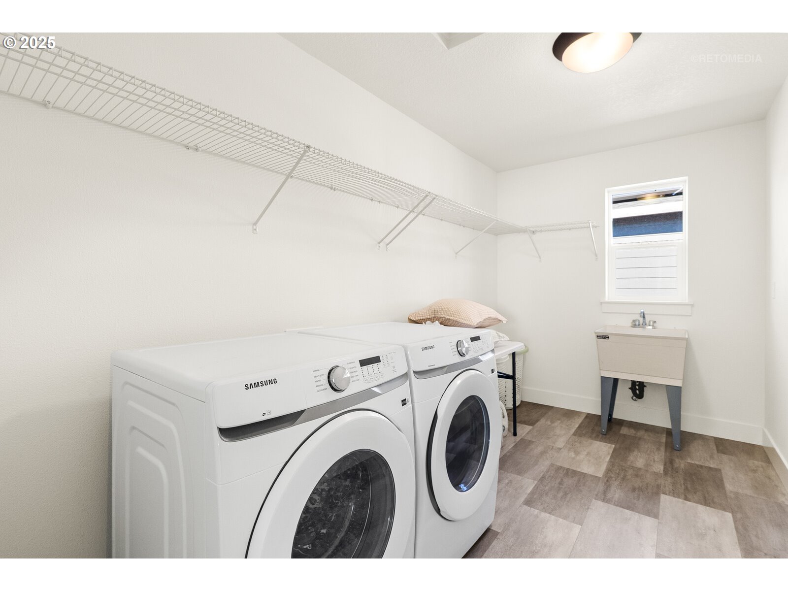 12305 Southwest Silvertip Street Beaverton, OR 97007 - Photo 34 of 43 a view of washer and dryer with kitchen in the background