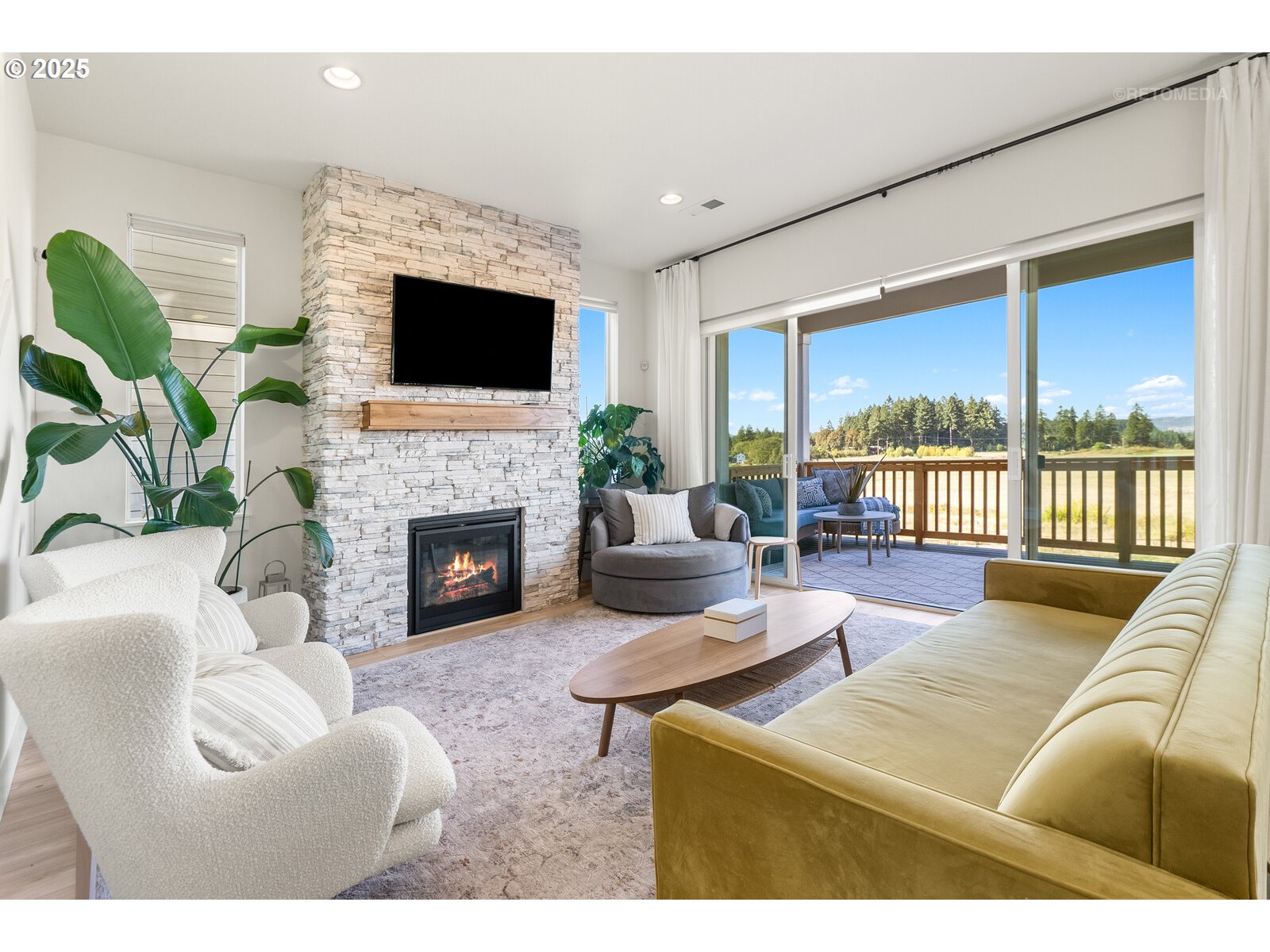 12305 Southwest Silvertip Street Beaverton, OR 97007 - Photo 5 of 43 a living room with furniture a flat screen tv and a fireplace