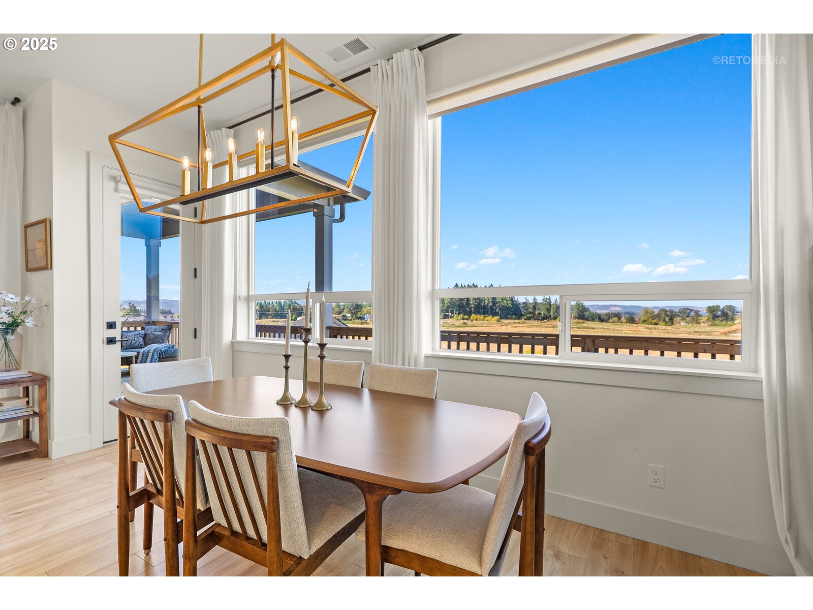 12305 Southwest Silvertip Street Beaverton, OR 97007 - Photo 10 of 43 a view of a dining room with furniture a chandelier and wooden floor