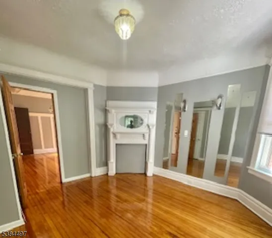 a view of a room with wooden floors and stairs