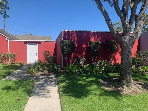 a view of a house with a tree in front of it