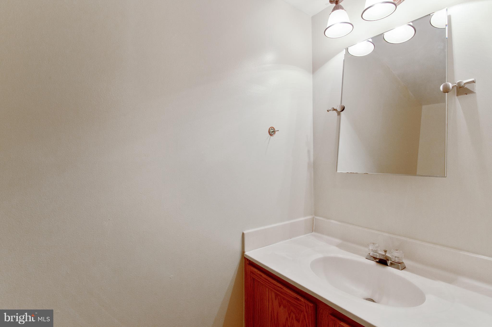 9304 Palmer Place, Unit 5 Laurel, MD 20708 - Photo 21 of 30 a bathroom with a sink vanity and a mirror