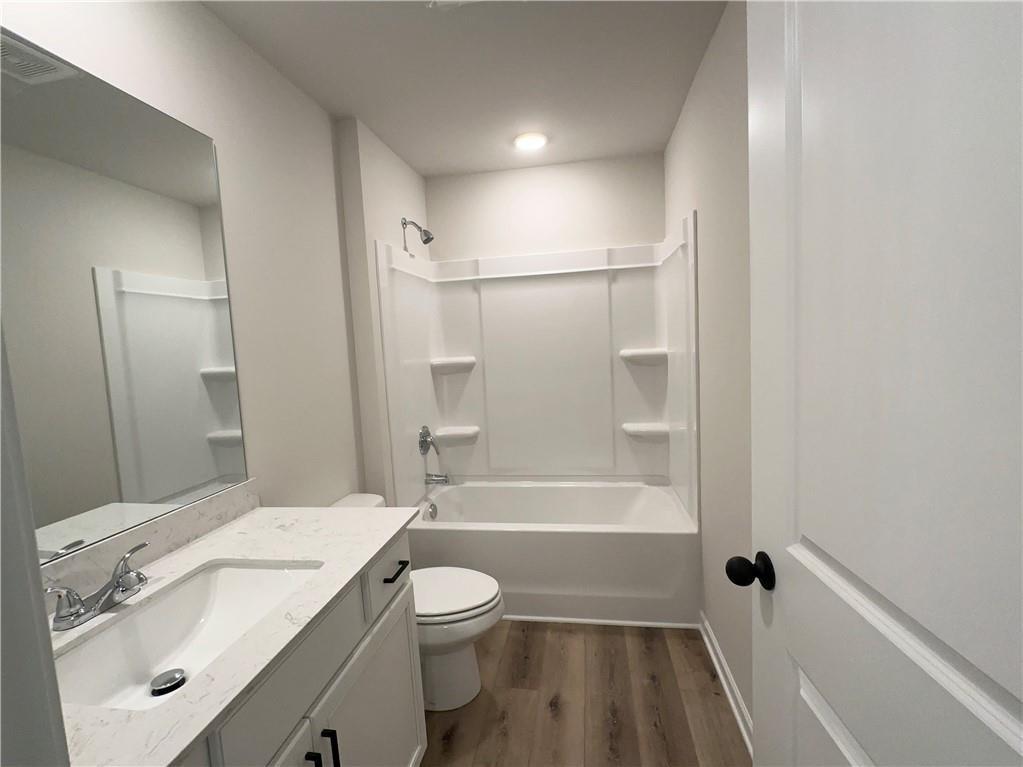 345 Rodeo Drive Auburn, GA 30011 - Photo 21 of 22 a bathroom with a sink a toilet and shower