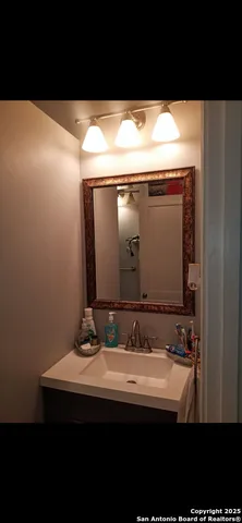 a bathroom with a sink and mirror