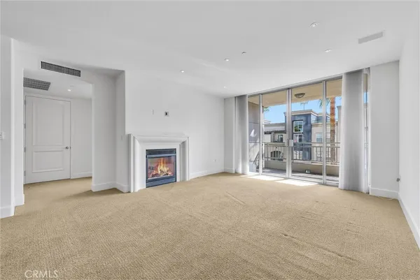 a view of an empty room with a fireplace